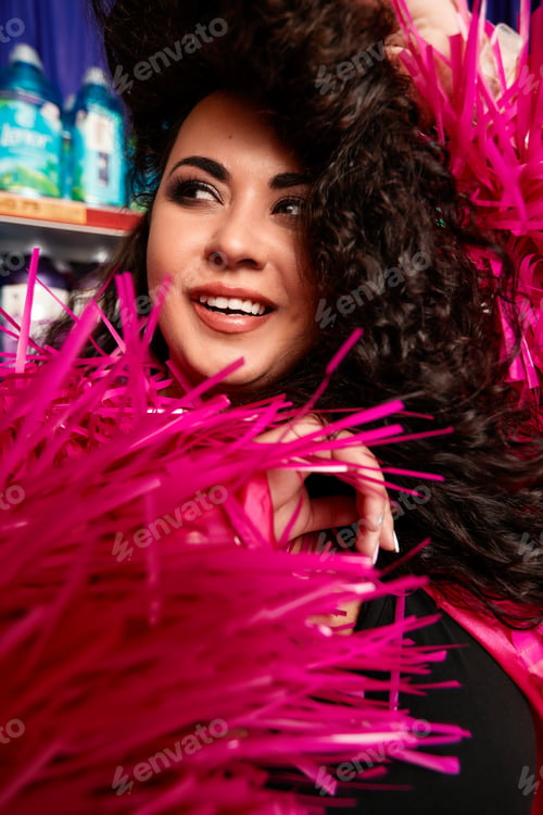 Preview: Female Plus size model posing in the studio, front face portrait, in rose feathers. The woman is