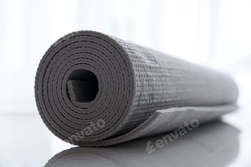 Preview: Rolled Up Grey Yoga Mat on Shiny Surface