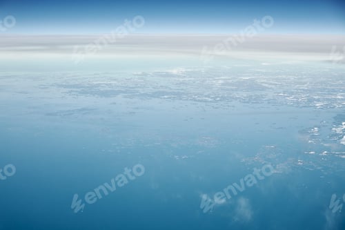 Preview: Aerial view from airplane window over clouds top to cold north sea, winter fresh frosty air