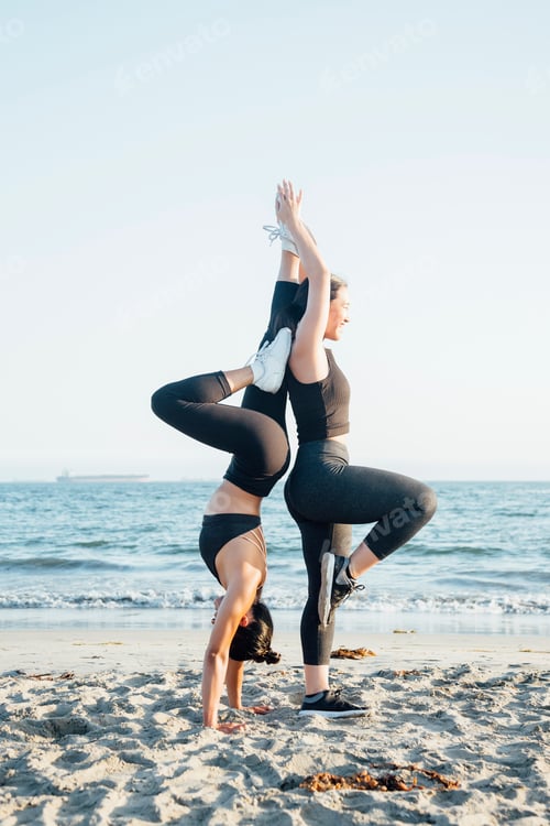 Preview: Friends doing exercises on beach