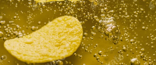 Preview: Deep fried potato chips under golden oil water.