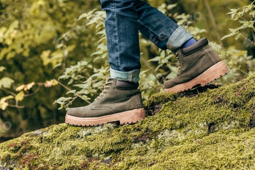 Preview: cropped shot of boy in autumn shoes walking on mossy log in park