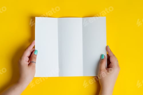 Preview: Trifold mock-up template paper brochure in woman's hands