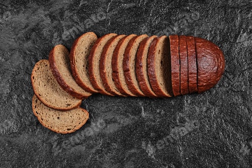 Preview: Sliced black bread on dark background