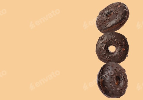 Preview: Tasty chocolate donuts on moccasin color background, space for text