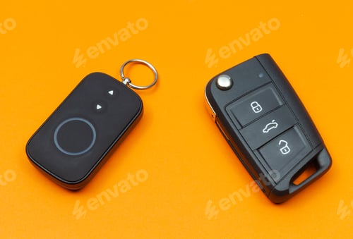 Preview: Car key with remote alarm control on the orange background