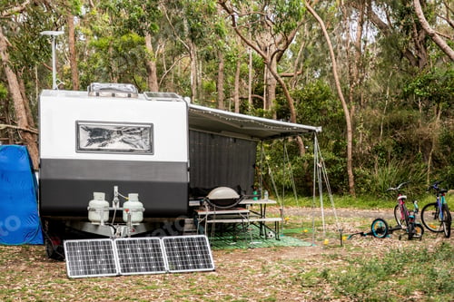 Preview: RV caravan camping at the caravan holiday park in the bush. Family vacation. Solar panels