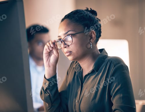 Preview: Serious black woman, computer and reading email, code or corporate information at night by the offi
