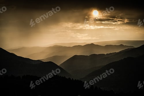Preview: banner of mountain peaks in beautiful stormy sunset light
