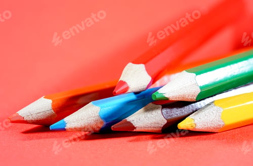 Preview: Set of colorful pencils on red background