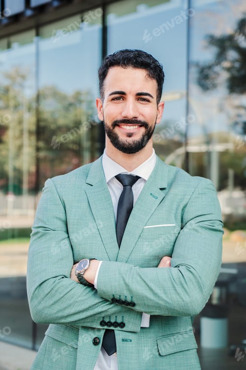 Preview: Vertical portrait of a handsome crossed arms business man executive looking at camera. Ambitious