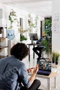 Preview: Project manager communicating with coworkers via video call