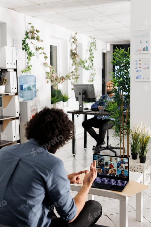 Preview: Project manager communicating with coworkers via video call