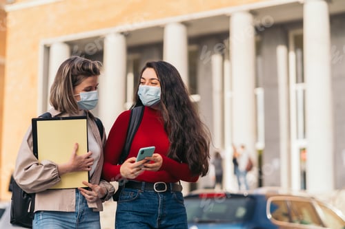 Preview: Two Young Women on Campus Wearing Face Masks