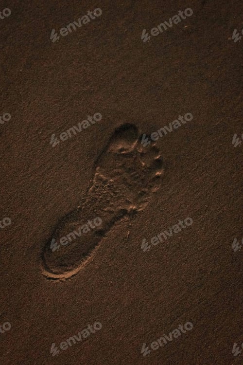 Preview: Close-up shot of a single human footprint in the sand