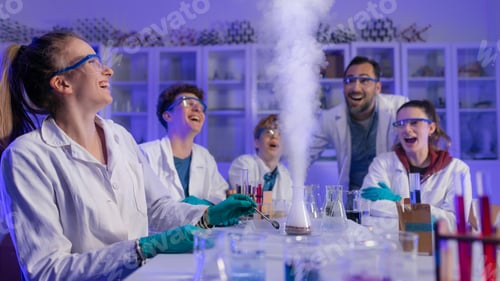 Preview: Excited science students with teacher doing chemical experiment in the laboratory at university.