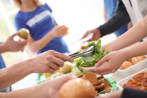 Preview: Volunteers serving food to poor people, closeup