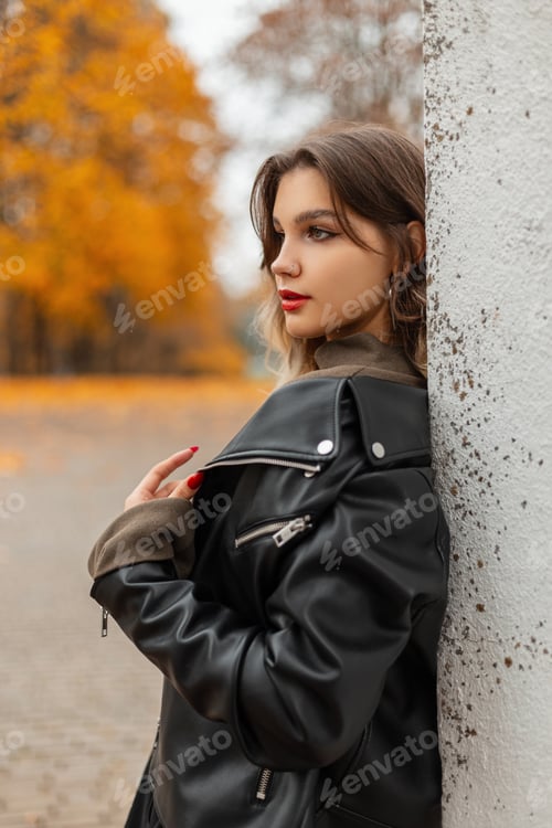 Preview: Beautiful young girl in fashion clothes with leather jacket on autumn day