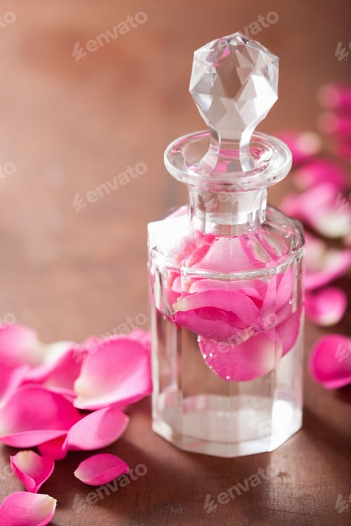 Preview: perfume bottle and pink rose flowers. spa aromatherapy