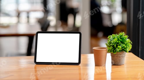 Preview: Tablet blank screen on desk and workspace background in modern office.