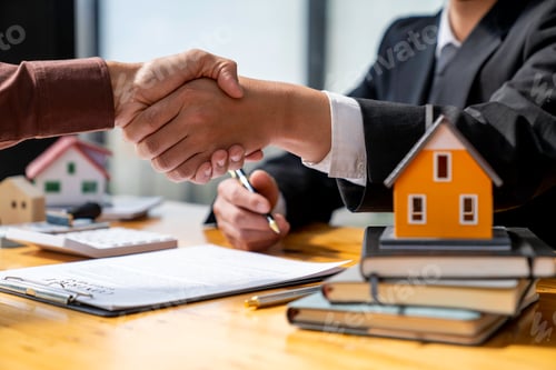 Preview: Successful deal Real estate lease or home purchase concept buyer shakes hands with bank employee aft