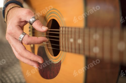 Preview: Close-up of man's hand playing guitar