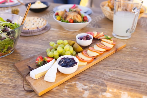 Preview: A wooden table prepared for a meal in the sunny garden
