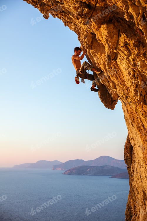 Preview: Rock climber on overhanging cliff