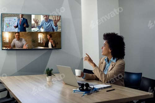 Preview: African American businesswoman having conference call with group of colleagues from the office.