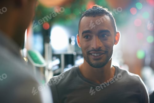 Preview: Young man in public house looking away smiling