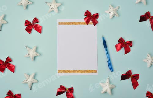 Preview: Blank sheet of paper with pen on blue background with Christmas decorations