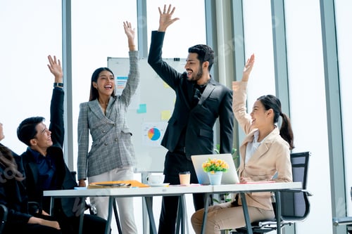 Preview: Asian business man and woman raise their hands up to express happiness and celebration
