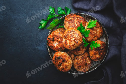 Preview: Homemade fried pork and beef meatballs in bowl, dark table background, top view