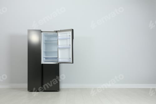 Preview: Modern refrigerator near light grey wall. space for text