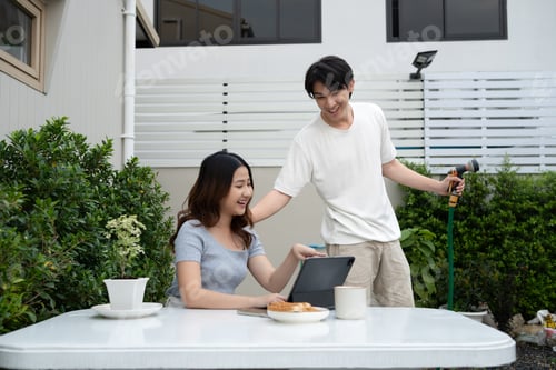 Preview: Beautiful couple enjoying leisure time in the backyard