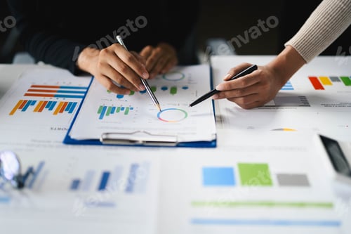 Preview: Business Team Analyzing Financial Charts and Graphs During a Meeting in a Modern Office