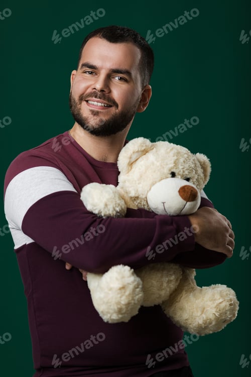 Preview: Bearded man holding teddy bear