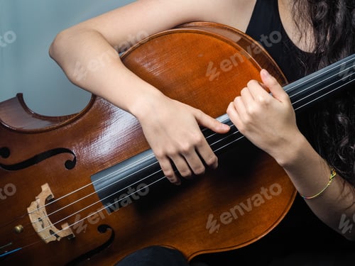 Preview: Closeup shot of a female holding the cello