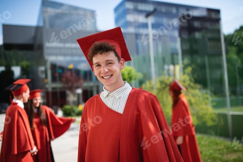 Preview: Portrait of cheerful male university student looking at camera, graduation concept