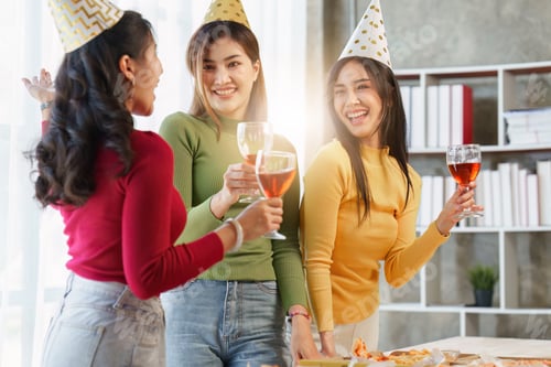 Preview: Friends at birthday party clinking glasses with champagne and pizza, enjoying christmas vacation, pi
