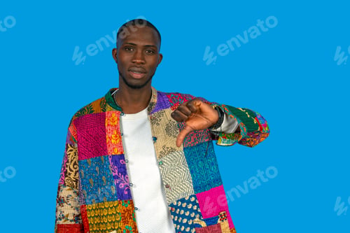 Preview: Black man giving thumbs down gesture expressing disapproval