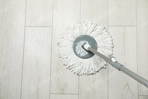 Preview: String mop on wooden floor, above view. Space for text