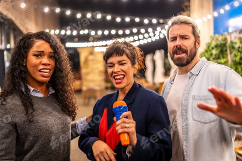Preview: Friends singing karaoke at night party in a bar terrace