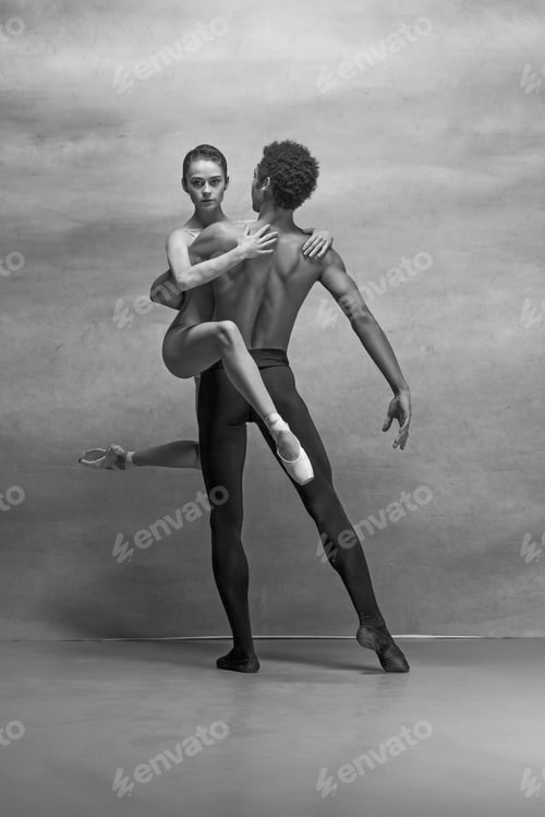 Preview: Couple of ballet dancers posing over gray background