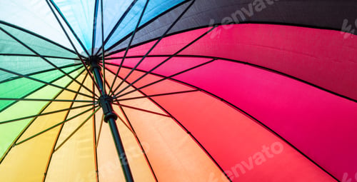 Preview: Rainbow color umbrella background. Multicolored spectrum colours sunshade, open, sunny day