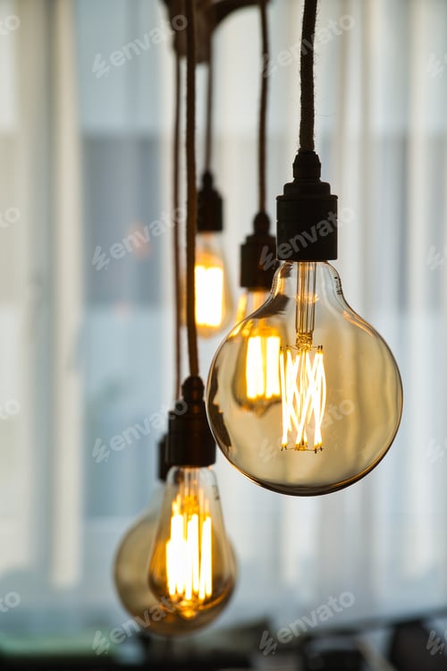 Preview: Vertical shot of hanging vintage light bulbs
