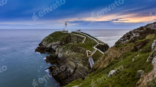 Preview: Aerial shot of South Stack Lighthouse under the blue sky at sunset in Wales