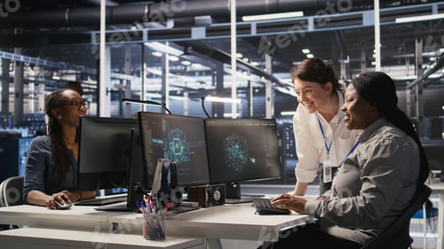 Preview: Cheerful data center technicians collaborating on AI automation deployment