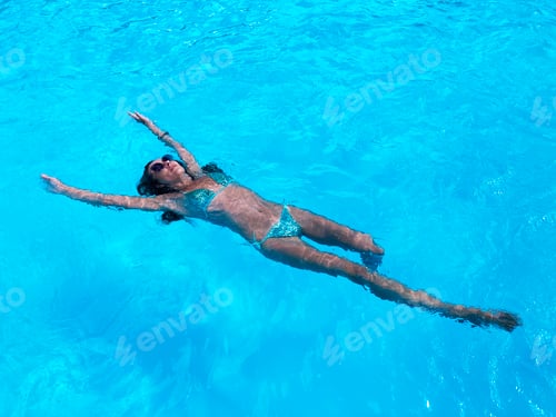 Preview: Young Woman Swimming in Poolside