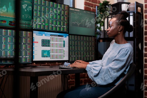 Preview: Brokerage agency agent sitting at multi monitor workstation while trading risk free assets.
